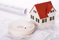 Smoke detector with house and blueprints