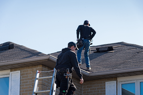 People replacing roof