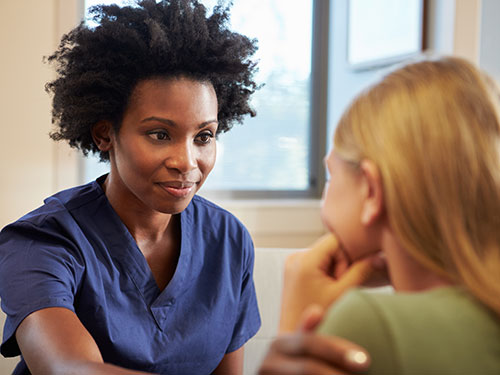 a female healthcare provider talking to a woman