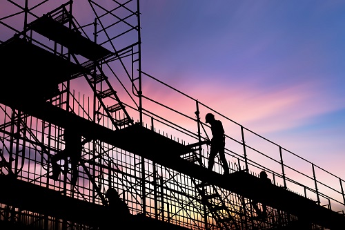 Construction worker walking on scaffolding